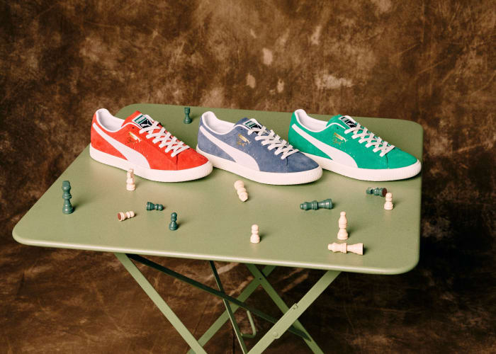 View of red, blue, and green Puma shoes on a table.